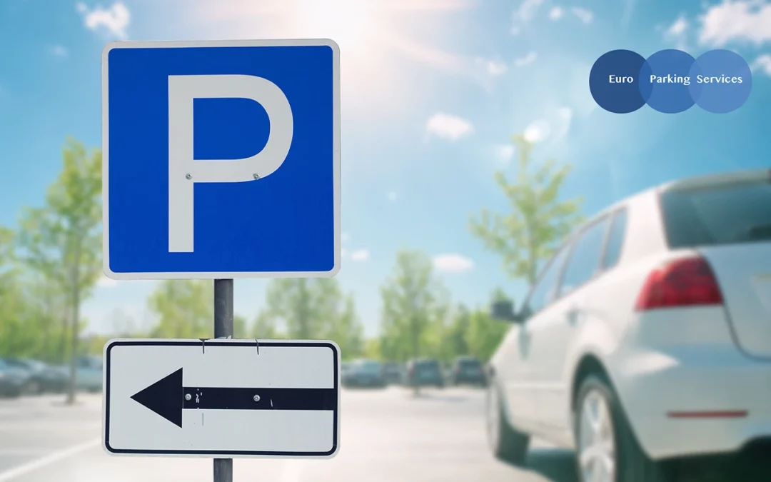 Parking sign with an outdoor car park, with parked cars and a moving white car in the background