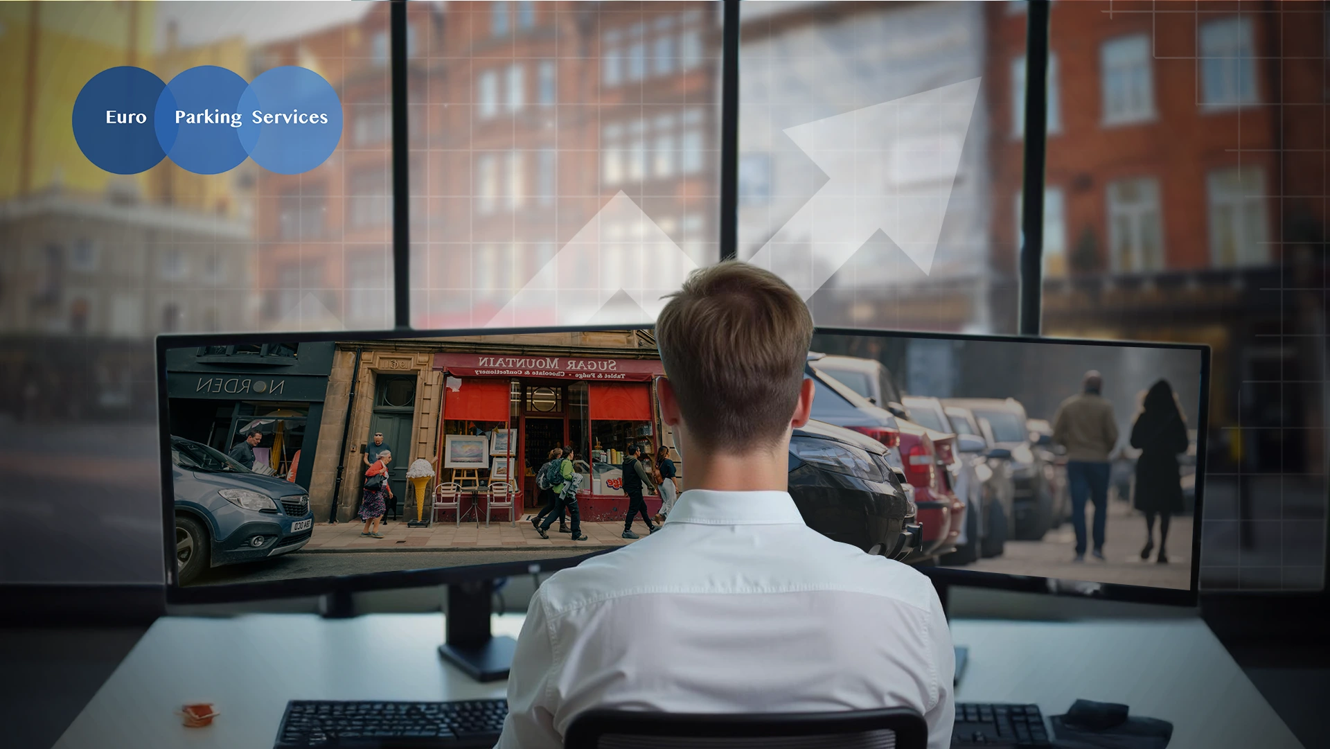 Man monitoring street activity on computer screens